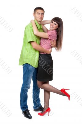 Embracing glamorous couple standing on white background