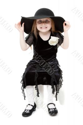 The little girl hamming in a black felt hat