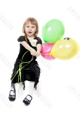 Little beautiful girl with balloons in the studio on a white bac
