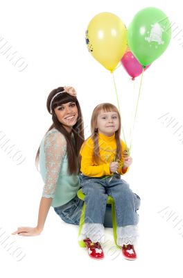 studio shot of mother and daughter with balloons