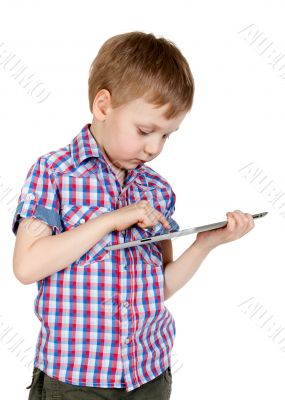 A boy in a plaid shirt with a tablet computer