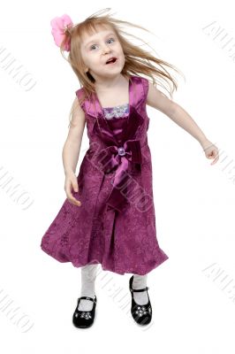 Full length of cheerful young girl jumping in joy over white bac