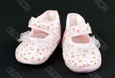 A pair of baby pink slippers
