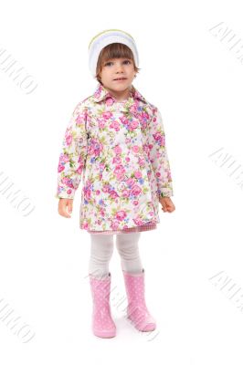 little girl in boots and a jacket in the studio