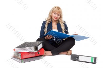 Beautiful girl sitting on the floor with folders for documents