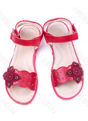 pair of a little girl`s red shoes