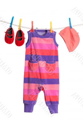 A set of children`s clothes hanging on a clothesline.