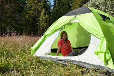 girl in a red dress in a tent in a forest