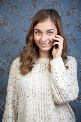 Woman talking on the phone on the background of the retro patter Woman talking on the phone on the background of the retro patter