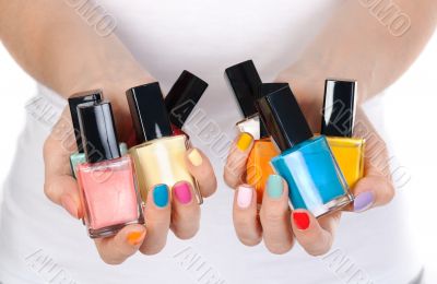 woman holding a bottle of nail polish woman holding a bottle of nail polish