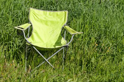Green folding chair on the grass