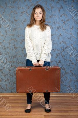 portrait of a beautiful girl with a suitcase