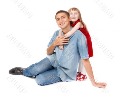 Smiling father and young daughter sitting on the floor Smiling father and young daughter sitting on the floor