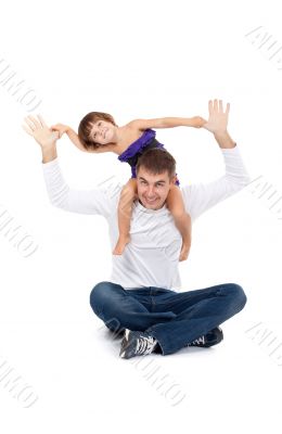 Cheerful daughter on the neck with his father in the studio