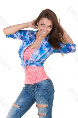 Glamorous young woman in shirt and jeans on white background