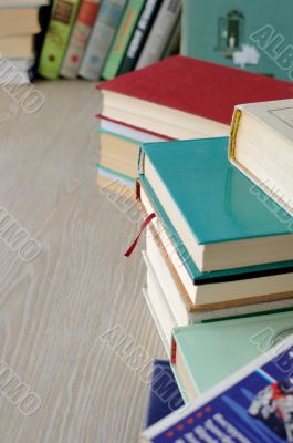 A variety of books in stacks on the table