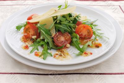 salad of arugula and cherry tomatoes with parmesan sauce