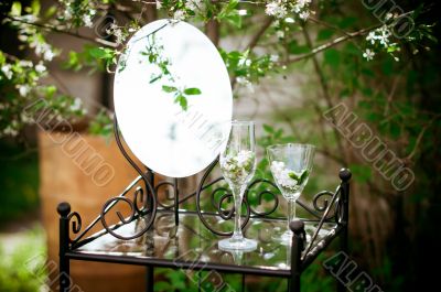 Table, mirror and glasses in the bush