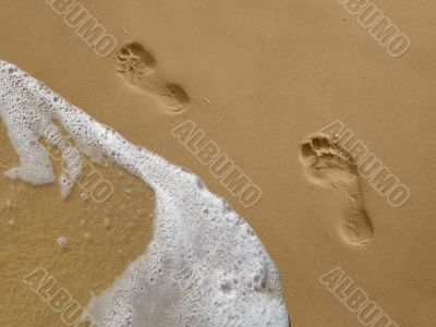 Footprints on the Beach with Water