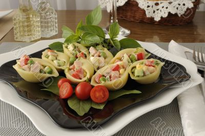 Sea shells pasta stuffed with vegetables and ham