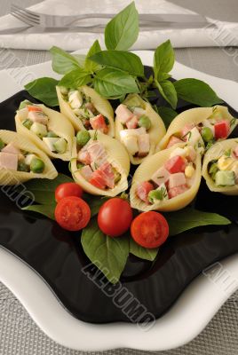 Sea shells pasta stuffed with vegetables and ham