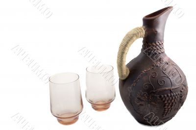 Ceramic jug for wine from red clay on a white background