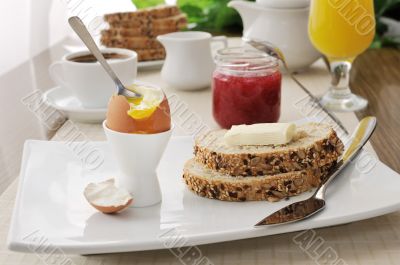 Breakfast with soft-boiled egg and slices of oatmeal bread