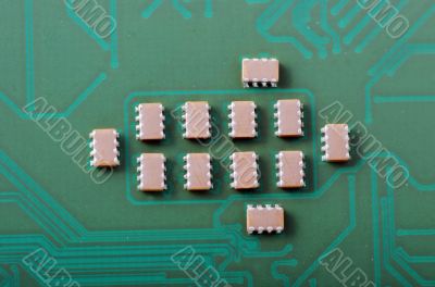 Green computer board with chips and components. 