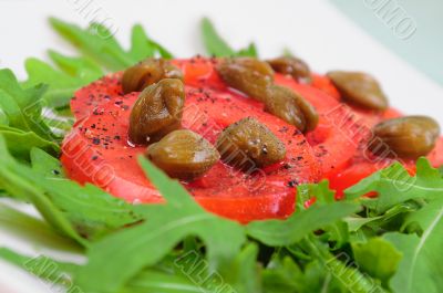 Salad with fresh tomatoes, capers and arugula