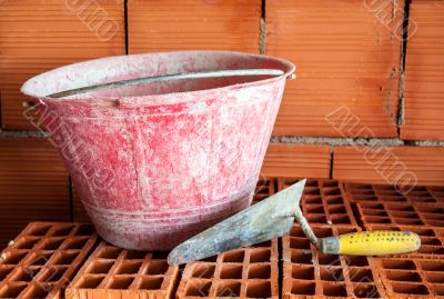 Trowel, bucket and bricks