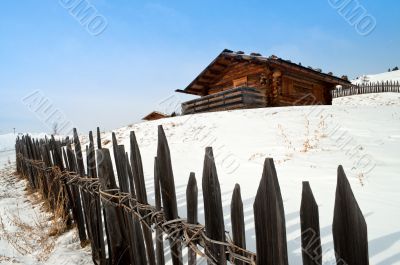 Old winter cottage with fence