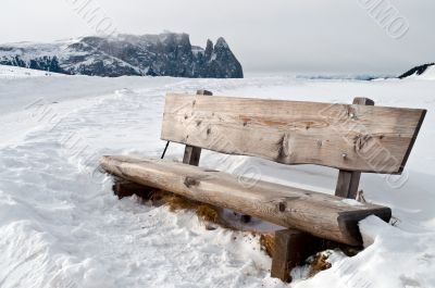 isolated bench in snow scape