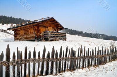 Old winter cottage with fence