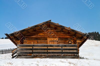 Old winter cottage with fence