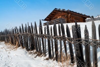 Old winter cottage with fence