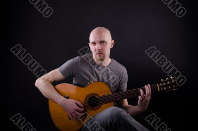 Nice bald guy with a guitar