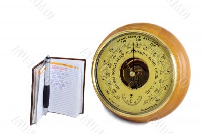 Barometer - aneroid and the notebook on a white background