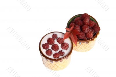 Berries raspberries and yoghurt in clay mugs on a white background