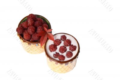 Berries raspberries and yoghurt in clay mugs on a white background