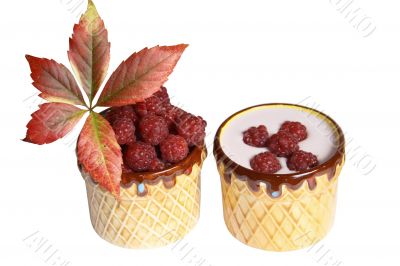 Berries raspberries and yoghurt in clay mugs on a white background