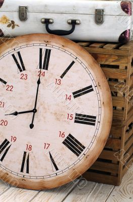 Vintage white suitcase on the box with clock