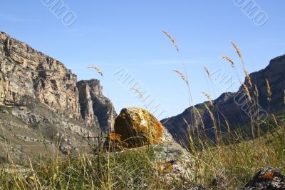 Stone on a background sky and mountains