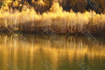 An autumn lake is in mountains