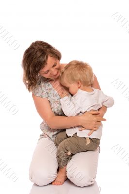 Young boy sitting on mother lap Young boy sitting on mother lap