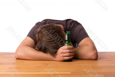Man sleeping on a table with beer Man sleeping on a table with beer
