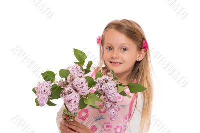 Happy little girl with lilac flowers