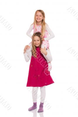 Young girl giving piggyback ride