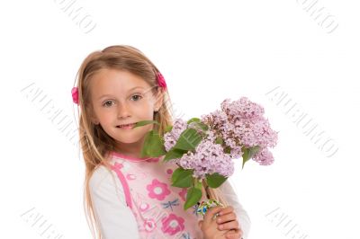 Happy little girl with lilac flowers