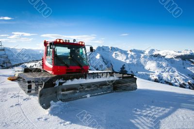 Snow-grooming machine on snow hill 