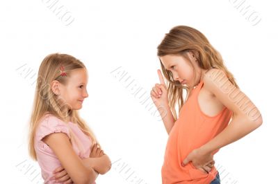 Young girl pointing finger at her sister